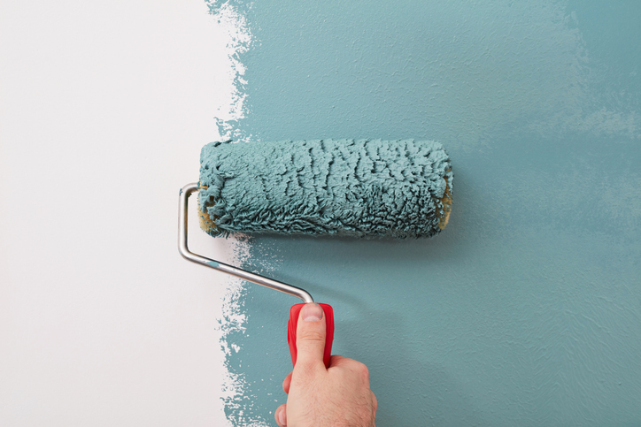 painting wall with paint roller